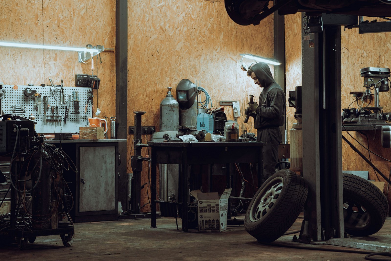A technician servicing a vehicle at The Home and Work's Fremont shop